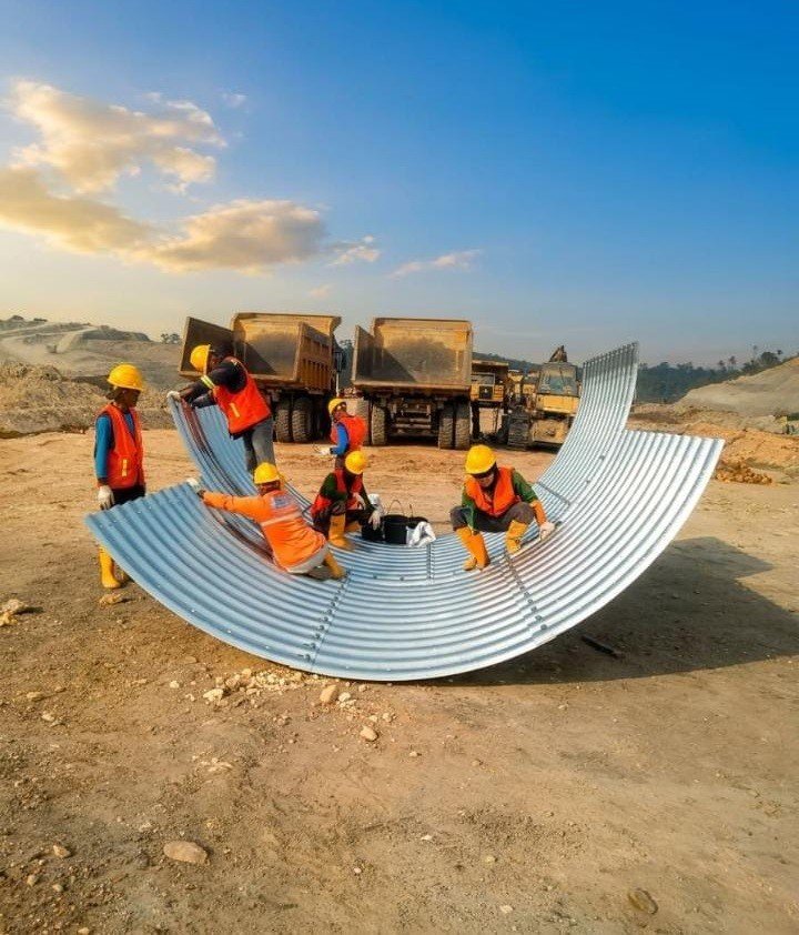 Pekerja merakit gorong-gorong baja Corrugated Steel Pipe di lokasi proyek